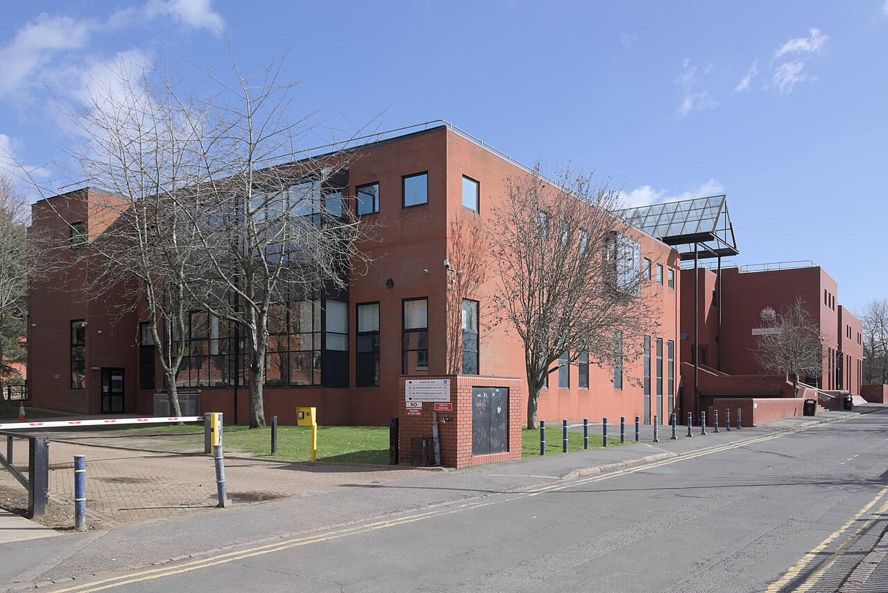 The Leicester Crown Court building, a red-brick block with a glass canopy, seen from the street
