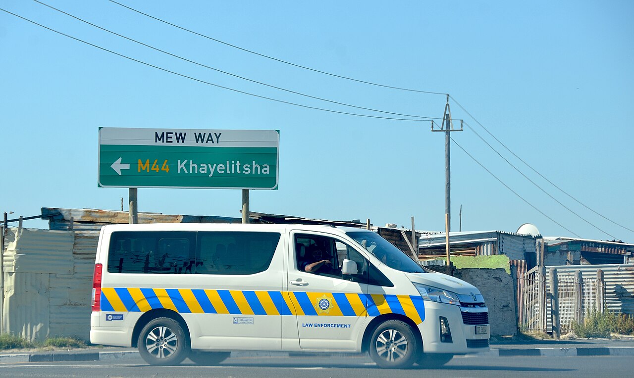 A South African law enforcement vehicle parked on a township street