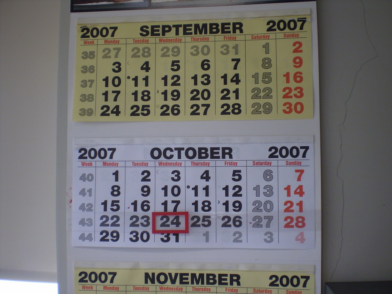 A wall calendar showing a grid of dates