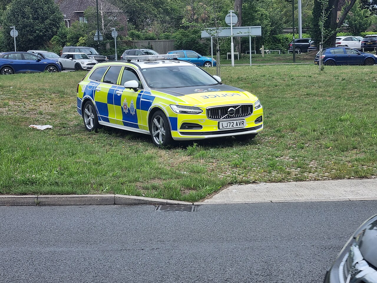 A Sussex Police Volvo patrol car parked on a grass verge