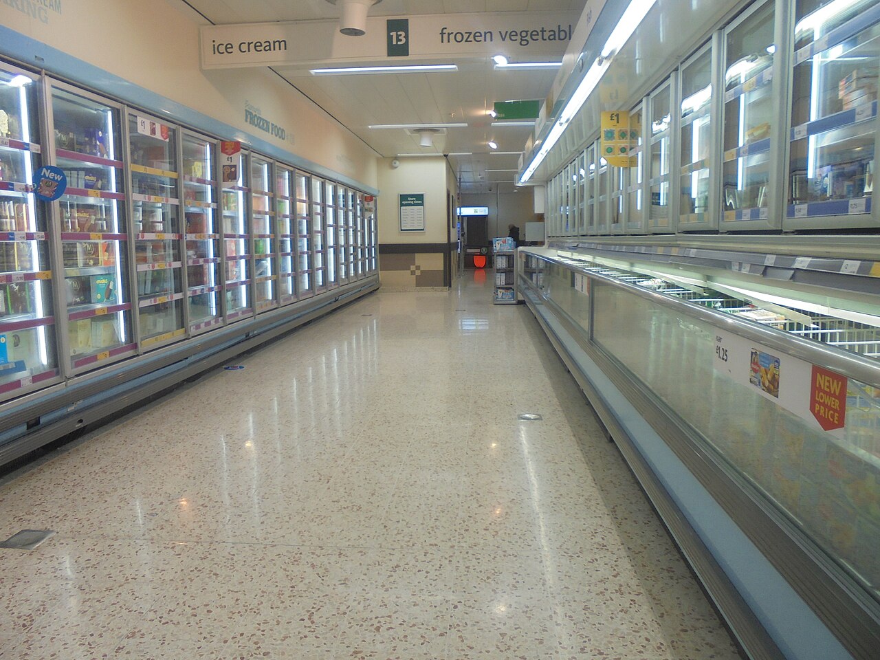 A supermarket aisle in Wetherby with freezer cabinets under a sign for ice cream and frozen vegetables