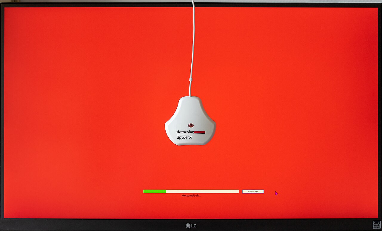 A colour calibration sensor measures colours on a monitor screen during a calibration test