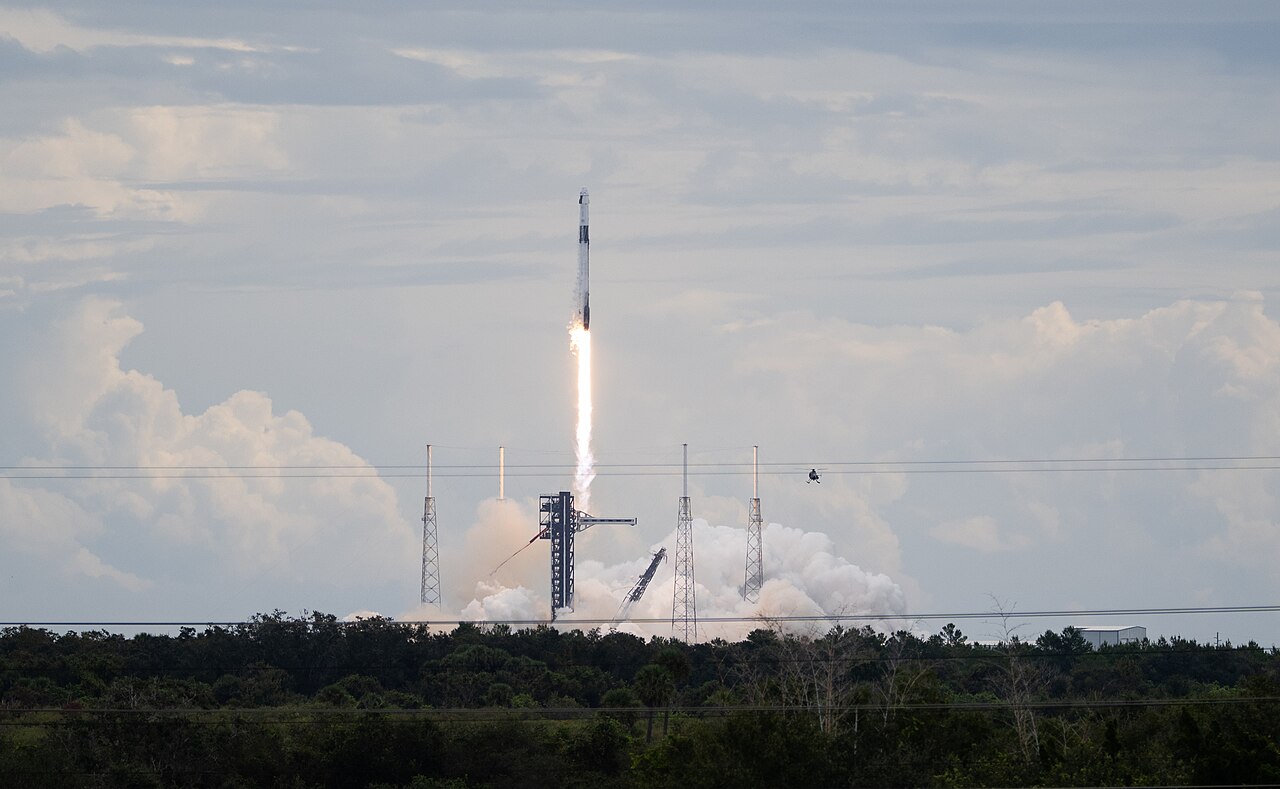 A SpaceX Falcon 9 rocket trailing flame and smoke as it lifts off from Cape Canaveral on the Crew-13 mission
