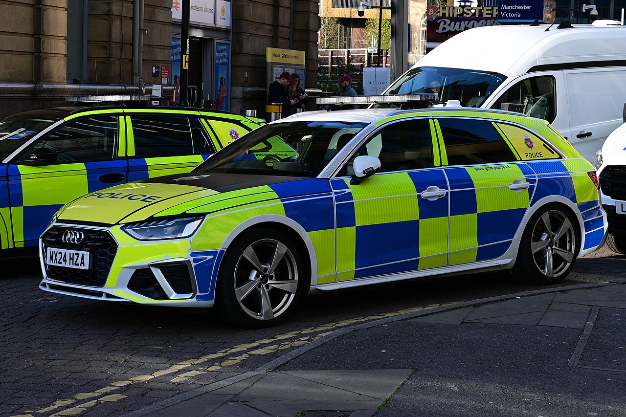 A Greater Manchester Police patrol car parked outside Manchester Victoria railway station.