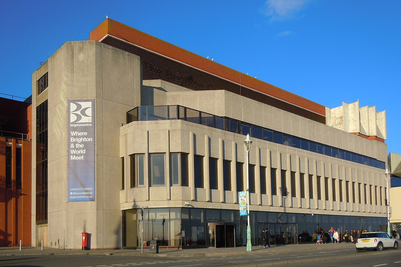 The Brighton Centre conference venue on King's Road, Brighton, seen from the street under a blue sky