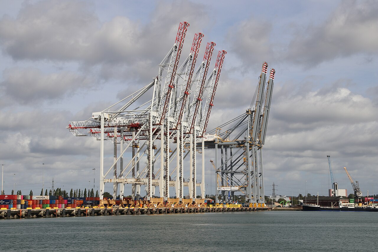 Quayside container cranes at the container port in Southampton under a cloudy sky