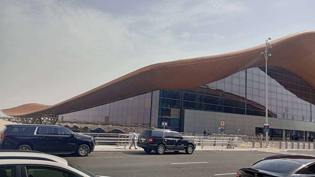 Exterior of the passenger terminal at Jeddah airport in Saudi Arabia, photographed in August 2025, with cars on the road in front
