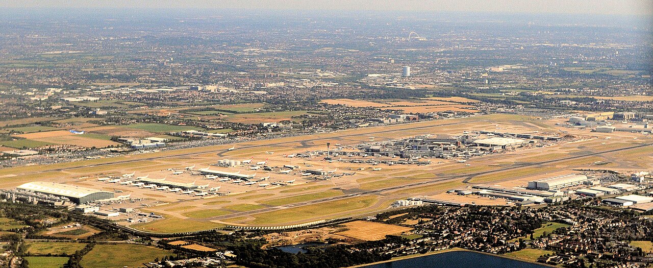 Aerial view of Heathrow Airport from the south-west, showing its two east-west runways, terminals and control tower