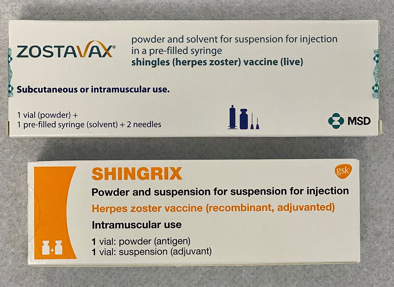 Two boxes of shingles vaccine side by side, one labelled as a live vaccine and one as a recombinant vaccine