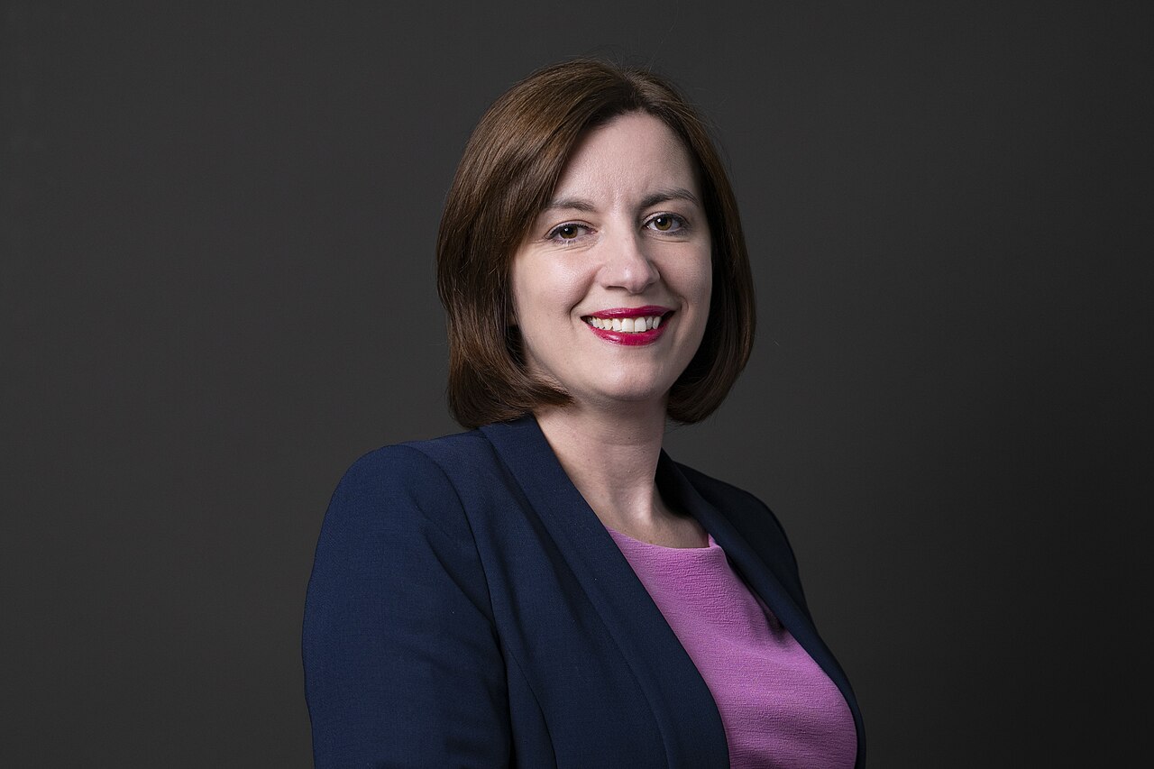 Bridget Phillipson, the minister for women and equalities, in an official portrait against a dark grey background.