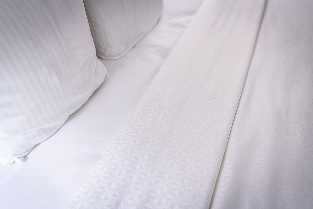 White pillows and neatly made bedding on a bed