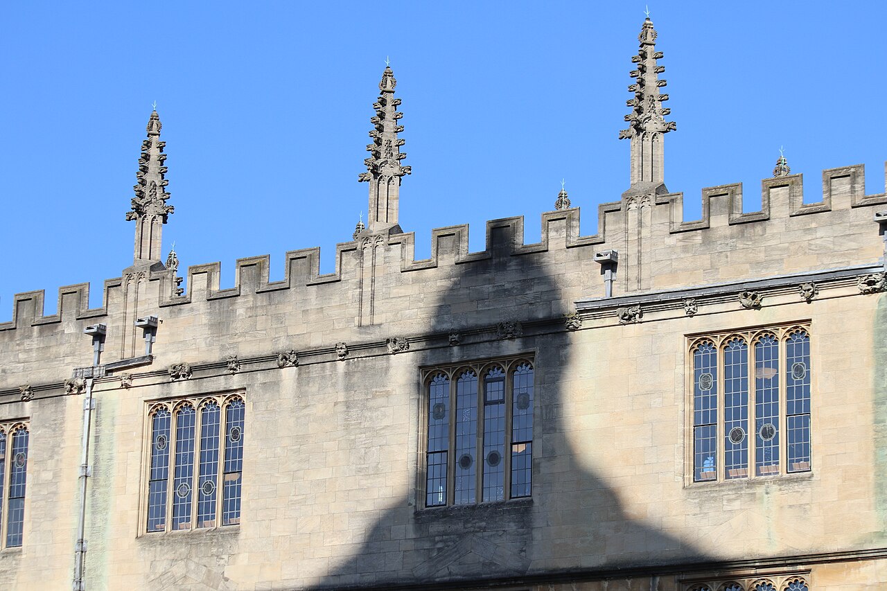 Stone pinnacles, battlements and leaded windows on the outside of the Bodleian Library in Oxford