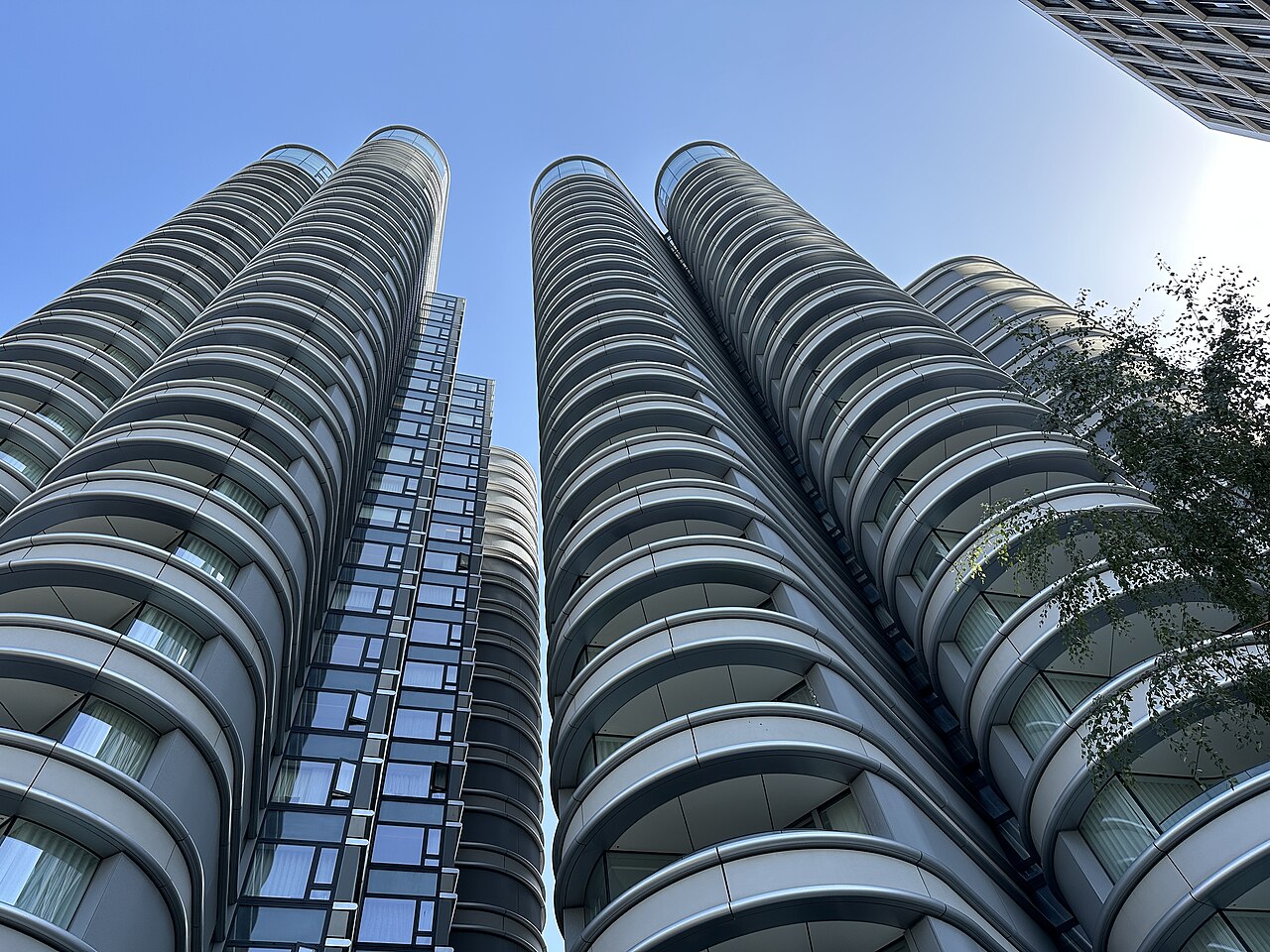 Curved glass and balcony facades of the Corniche towers on Albert Embankment in London, seen looking up from street level