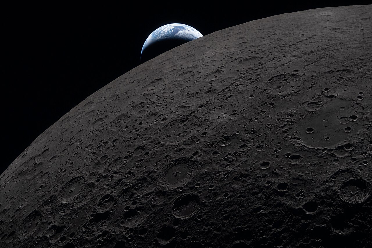 Earth rising as a thin blue crescent above the cratered grey limb of the Moon, photographed from the Orion spacecraft