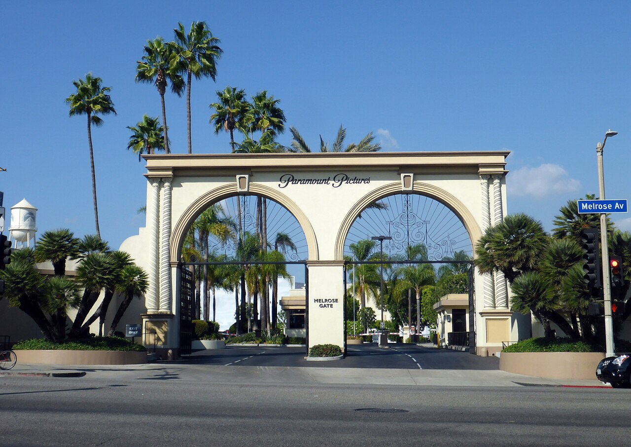 The Melrose Gate entrance to the Paramount Pictures studio lot in Hollywood, Los Angeles, with palm trees and a water tower behind