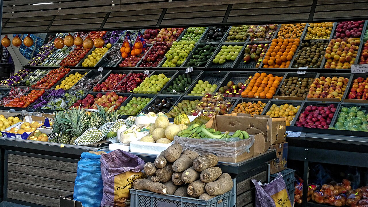A fruit and vegetable display outside a shop in Tottenham, north London, with crates of apples, oranges, kiwi fruit, bananas and pineapples