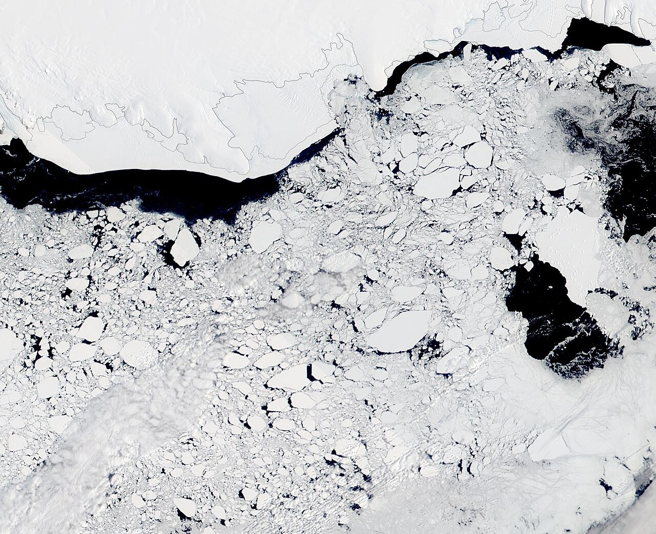 Satellite image of Antarctic sea ice breaking into scattered floes near the coast