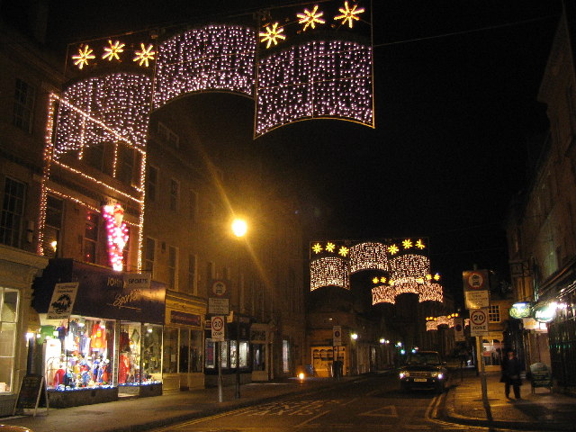Christmas lights strung over a shopping street at night